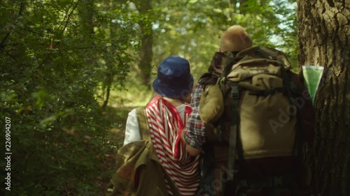 Wallpaper Mural Young couple with backpacks having a walk in the forest Torontodigital.ca