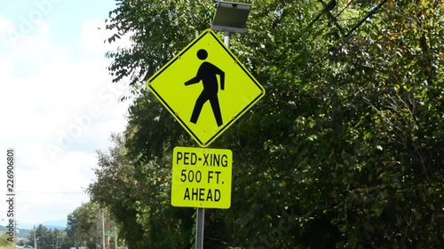 Pedestrian crossing sign with flashing lights.