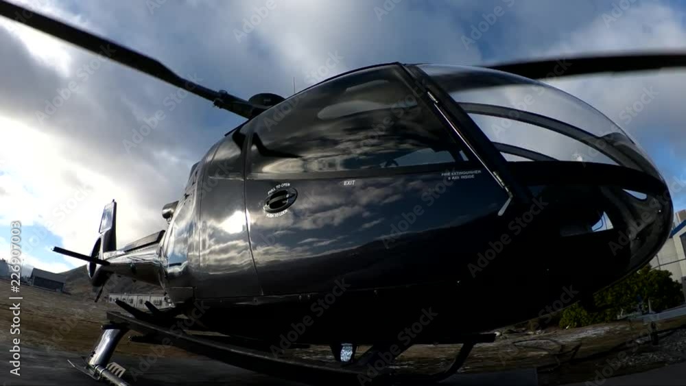 Helicopter rotors spin in slow motion, low angle Helicopter rotors spin in slow motion, low angle