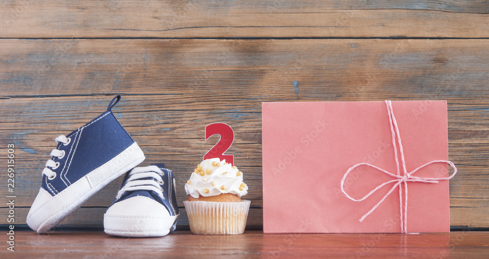 Delicious birthday сupcakes for a baby shower on wooden background Delicious birthday сupcakes for a baby shower on wooden background
