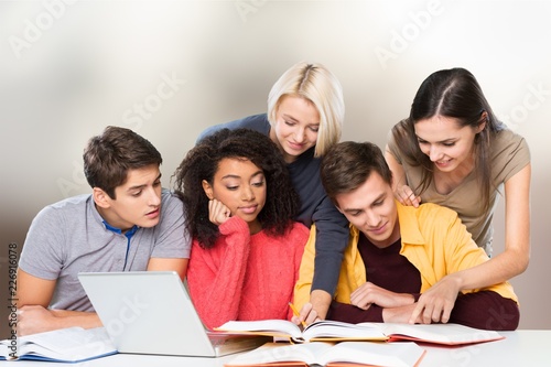 Young students studying on library background