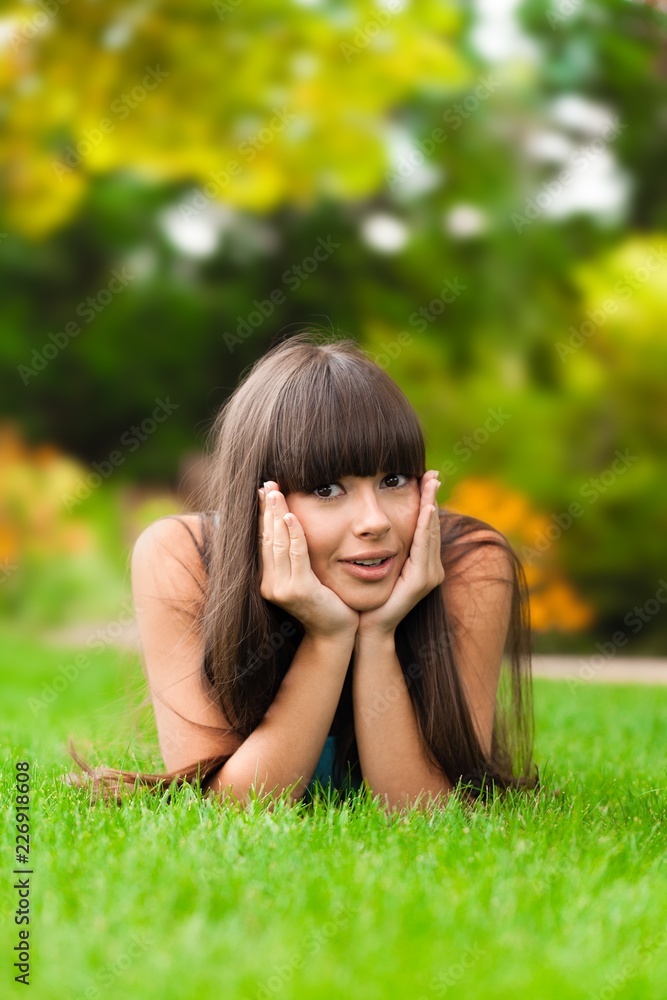 Portrait of a Young Woman Lying Down on the Grass Portrait of a Young Woman Lying Down on the Grass