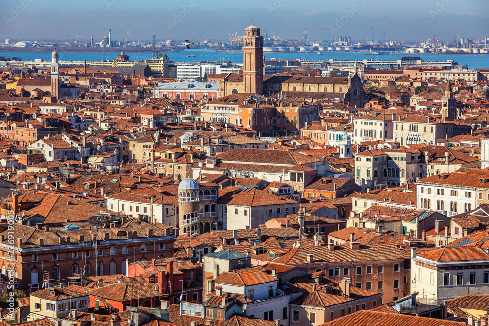 Venice panoramic aerial view with red roofs, Veneto, Italy. Aerial view with dense medieval red roofs of Venice, Italy