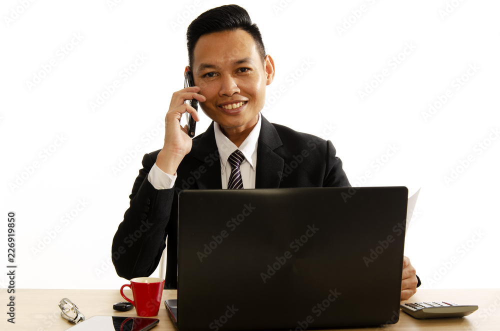 Asian business man smile and using smartphone and labtop computer on white backgrounds Asian business man smile and using smartphone and labtop computer on white backgrounds