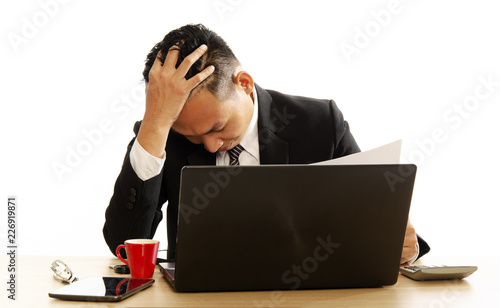 Asian business man using laptop computer at office desk on white backgrounds