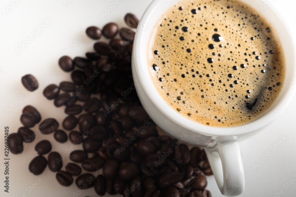 Closeup of cup of espresso and coffee beans Closeup of cup of espresso and coffee beans