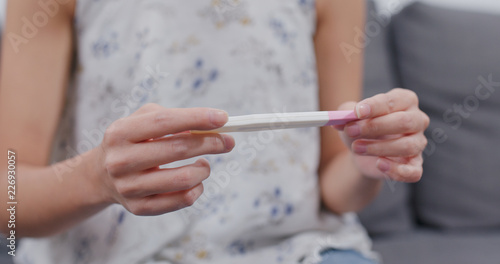 Woman hold pregnancy test stick