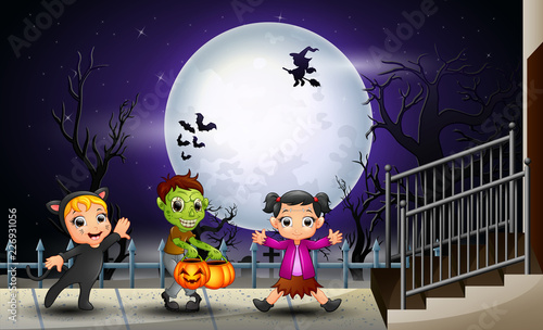 Happy kids halloween in the full moon background