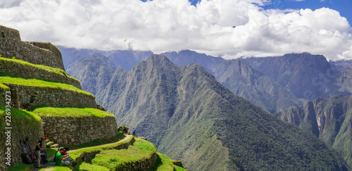 Blue cloudy sky above green terraced mountainside on the Inca Trail in Peru
