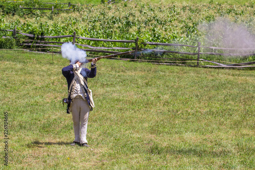 American Revolutionary War Reenacter Fires his gun