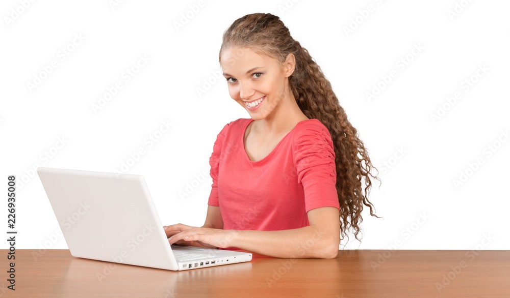Girl Sitting Behind Desk and Using Laptop - Isolated Girl Sitting Behind Desk and Using Laptop - Isolated