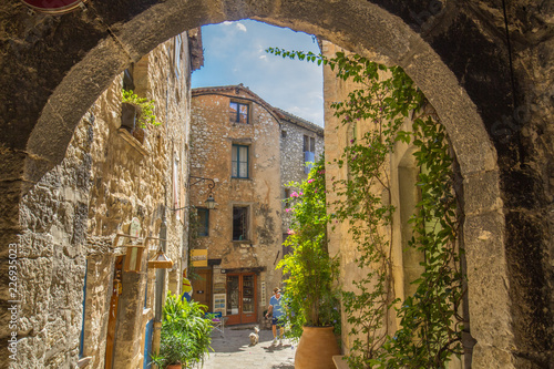 Looking through an arch at a quaint side street in Tourrettes-sur-Loup, France