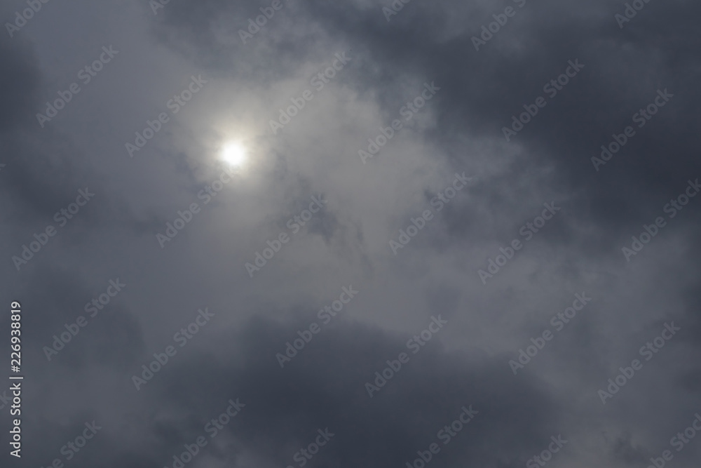 The dark blue gray layer of clouds in the sky covered the sun. Abstract clouds background, pattern, climate change and weather forecast.