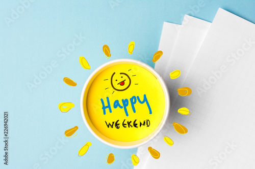 Happy weekend quote and coffe cup on blue background. Time to break concept. photo