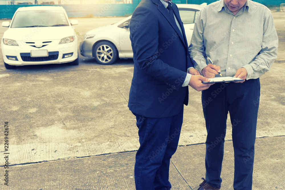 On the road car accident insurance agent examining carcrash On the road car accident insurance agent examining carcrash