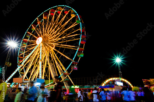 Carnival, Amusement park at night Ferris wheel in motion,Light night city.