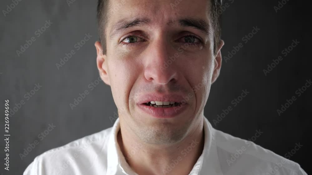 Portrait of sad man crying with tears in eyes. Depressed businessman crying. Man in despair. Portrait of sad man crying with tears in eyes. Depressed businessman crying. Man in despair.