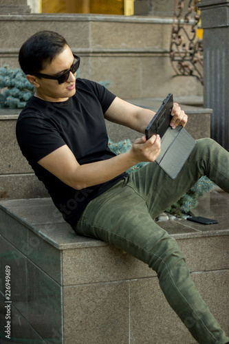 Gaming asian young man with tablet © Roman