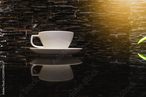 Close-Up of Hot Coffee Cup and Spoon on Granite Table Top in Cafe Shop  Fresh Espresso Caffeine Coffee in Ceramic Cup on Counter Bar Cafe  With Copy Space. Food and Beverage Concept