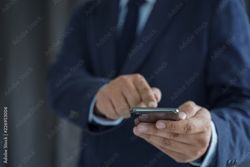 Business man hold the smartphone on the street and copy space. Business man hold the smartphone on the street and copy space.