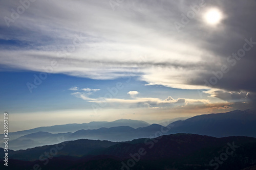 sunset in the clouds on a mountain background