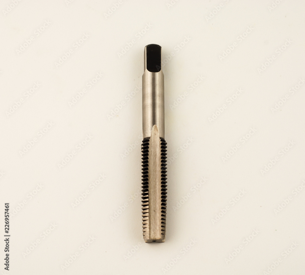 Cutting tool to make thread known as hand tap on white background Cutting tool to make thread known as hand tap on white background