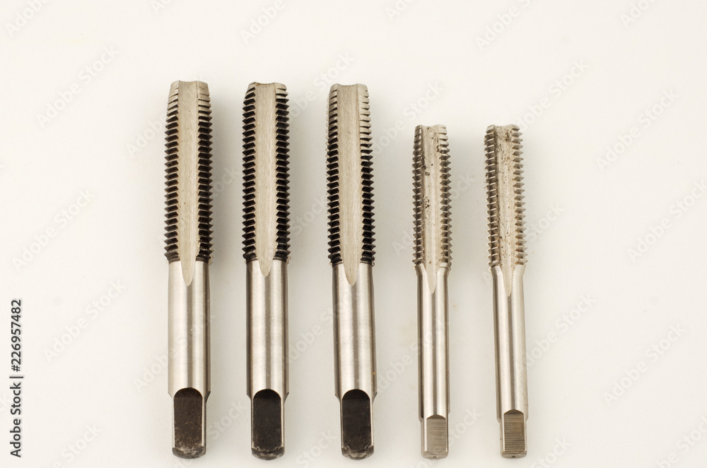 Cutting tool to make thread known as hand tap on white background Cutting tool to make thread known as hand tap on white background