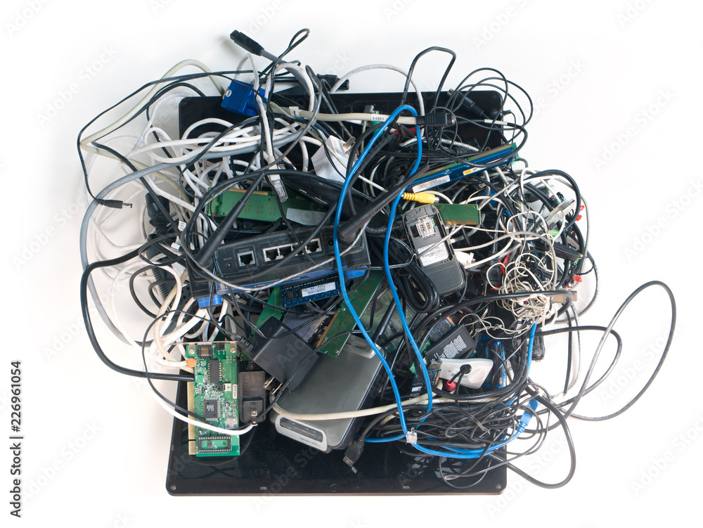 Ewaste mess. A jumbled up pile of old wires cables, power adapters