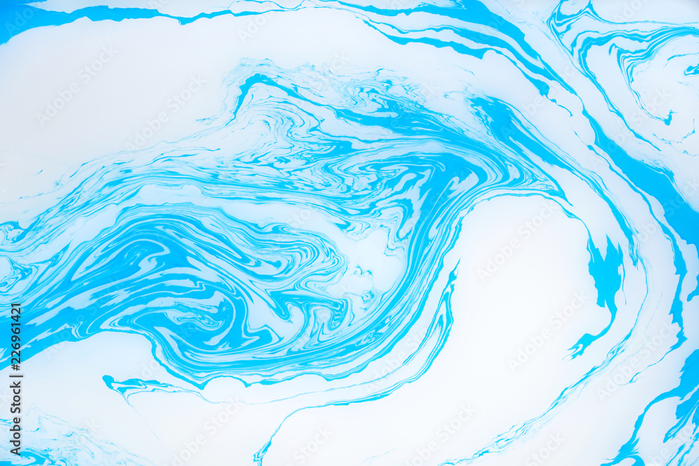 Abstract blue marble background. Stains of paint on the water. Abstract blue marble background. Stains of paint on the water.