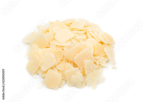 Pile of parmesan cheese flakes and crumbs isolated