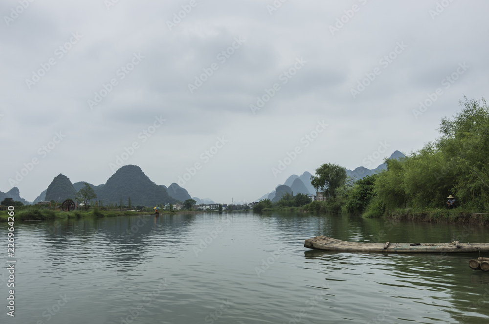 Beautiful karst mountains are visible on blue sky background on summer sunny day. Beautiful karst mountains are visible on blue sky background on summer sunny day.