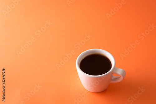 cup of coffee on orange background