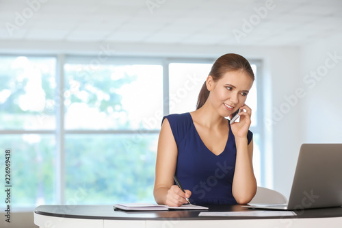 Young businesswoman working in office © Pixel-Shot