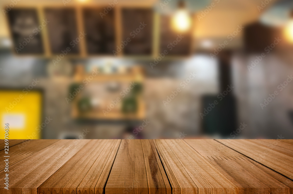 Selected focus empty brown wooden table and Coffee shop or restaurent blur background with bokeh image. for your photomontage or product display. Selected focus empty brown wooden table and Coffee shop or restaurent blur background with bokeh image. for your photomontage or product display.