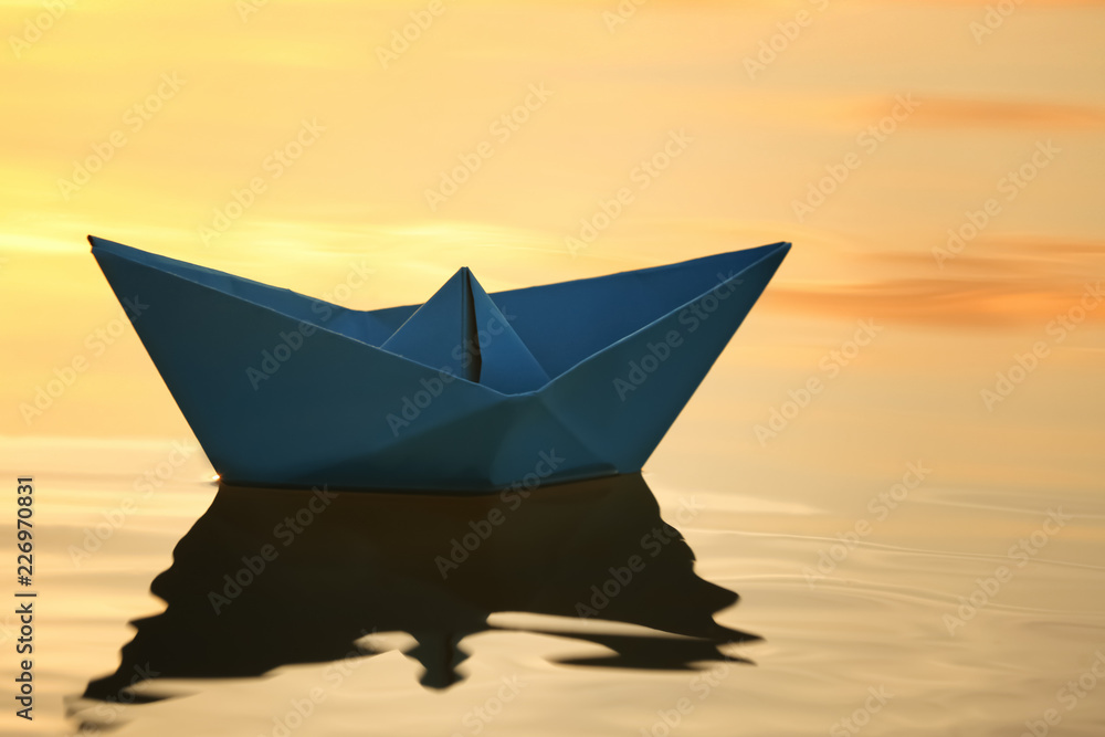 Origami boat on water surface
