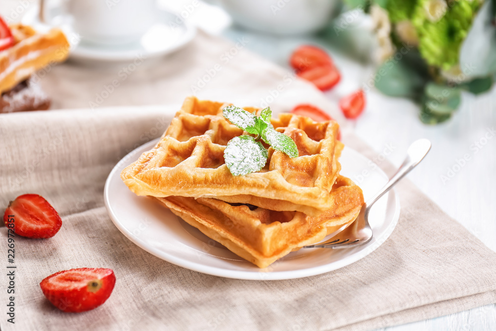 Plate with delicious waffles on table Plate with delicious waffles on table