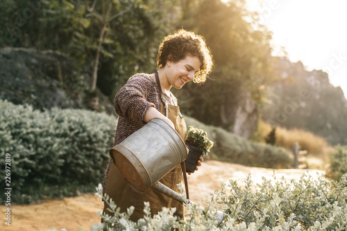 Woman taking care of the flowers at her countryside home photo