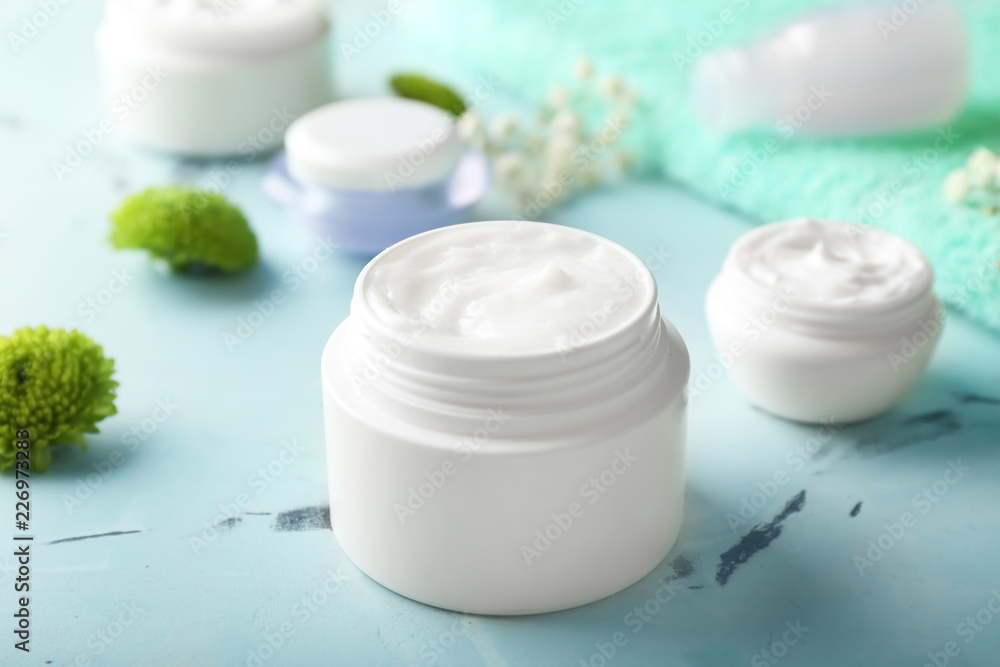 Jar with natural body cream on color table Jar with natural body cream on color table