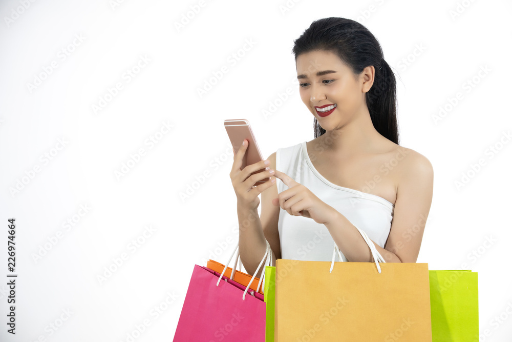 Asian women and Beautiful girl is holding shopping bags and using a smart phone and smiling while doing shopping and buy with credit card Asian women and Beautiful girl is holding shopping bags and using a smart phone and smiling while doing shopping and buy with credit card