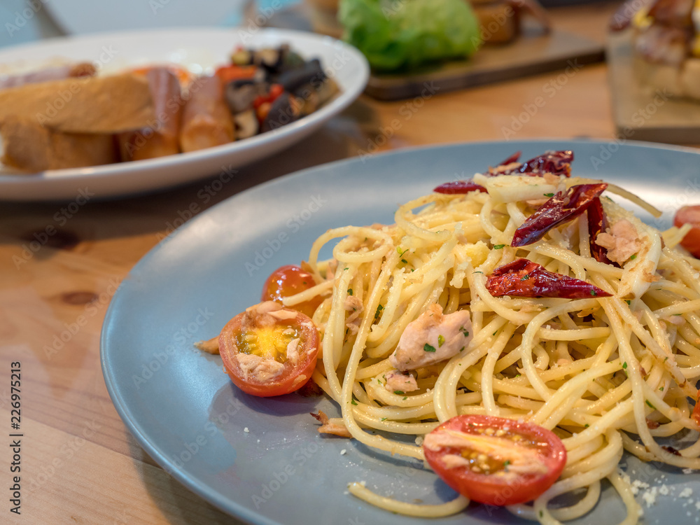 Spicy tuna olive spaghetti by top view image. New fusion menu between Italian traditional food with Thai style. Food design for who like hot and spicy tasty. Temptation menu for every meal in day. Spicy tuna olive spaghetti by top view image. New fusion menu between Italian traditional food with Thai style. Food design for who like hot and spicy tasty. Temptation menu for every meal in day.