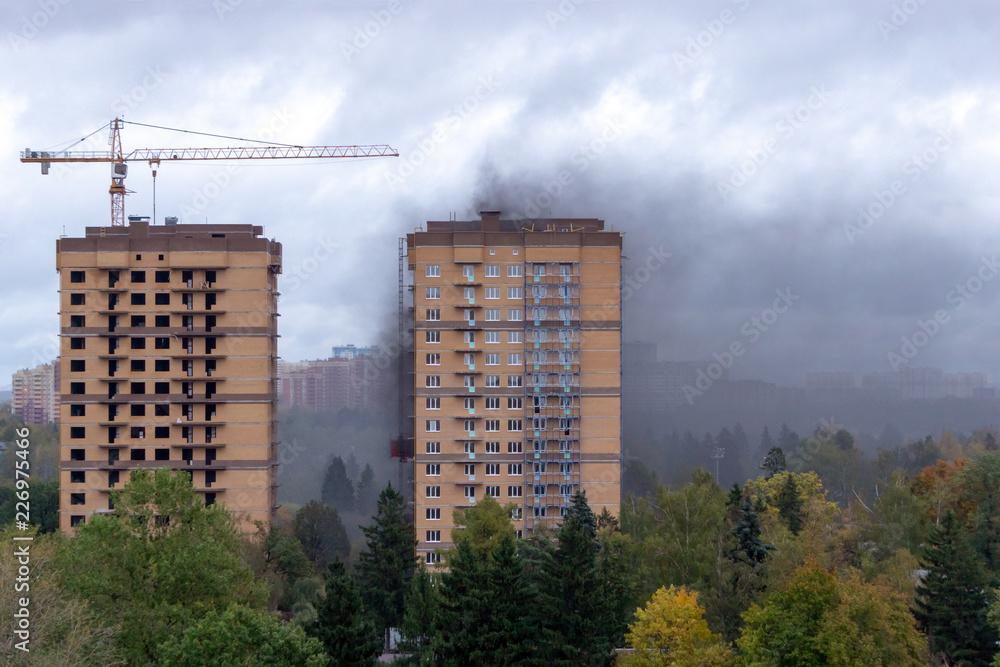 Fire and smoke in a high-rise building under construction Fire and smoke in a high-rise building under construction