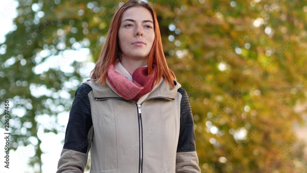 Close up of cute autumn girl in the park. Looking at camera and smiling Close up of cute autumn girl in the park. Looking at camera and smiling