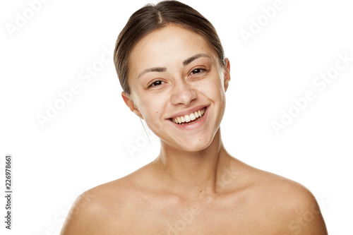 Portrait of young beautiful happy woman with no makeup on white backgeound