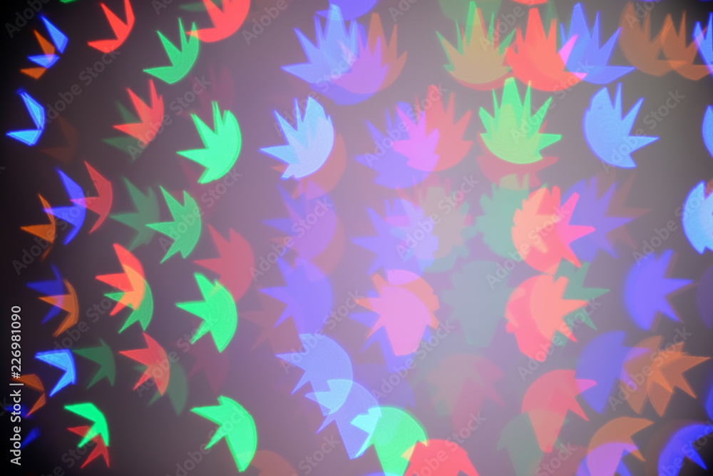 Fototapeta premium Blurred view of beautiful lights on dark background
