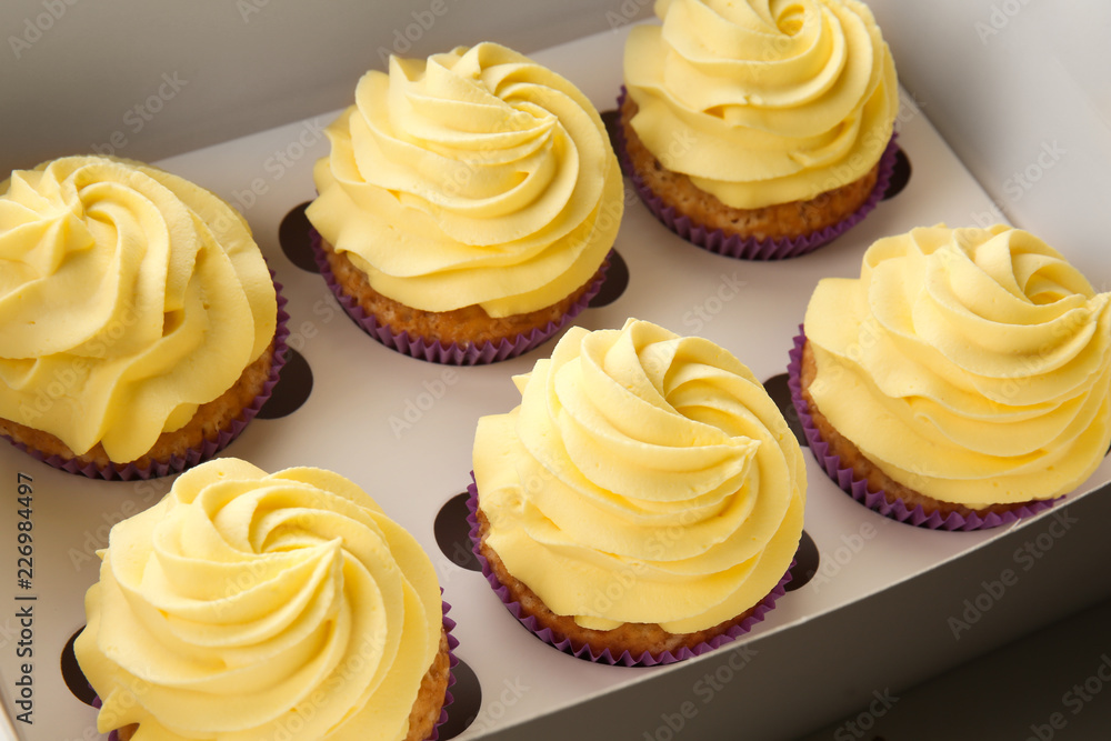 Delicious lemon cupcakes in box, closeup Delicious lemon cupcakes in box, closeup