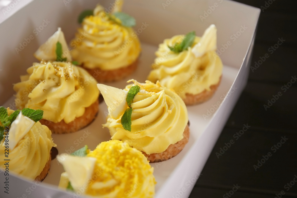 Delicious lemon cupcakes in box, closeup Delicious lemon cupcakes in box, closeup