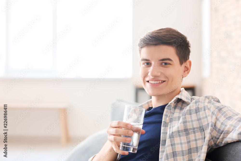 Young man with glass of water at home Young man with glass of water at home