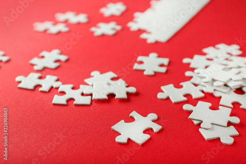 Scattered white puzzle piec...