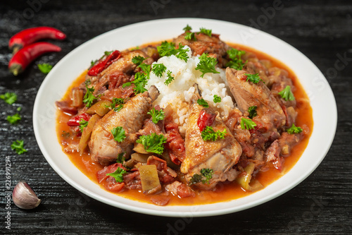 Chicken chilindron with thick vegetable sauce with red wine and dry-cured ham. 