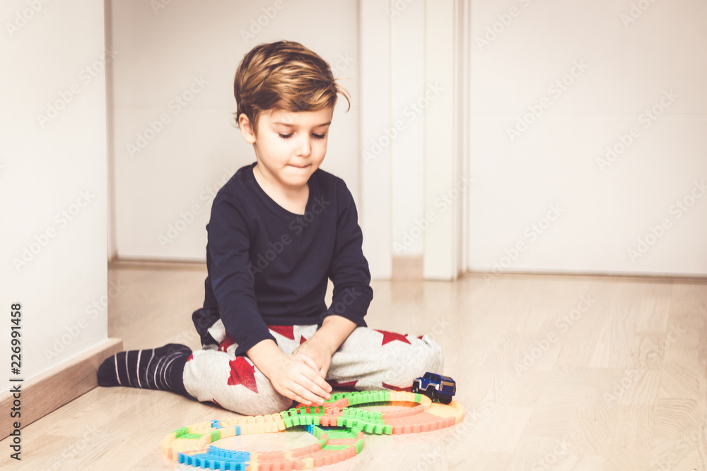 Little boy playing with car toy at home. Little boy playing with car toy at home.